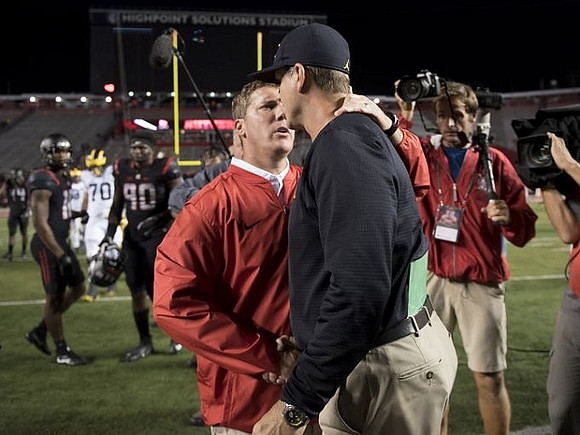 Rutgers Head Coach Chris Ash and Jim Harbaugh