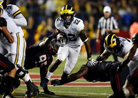 Michael Onwenu (50), Karan Higdon (22), and Juwann Bushell-Beatty (76)