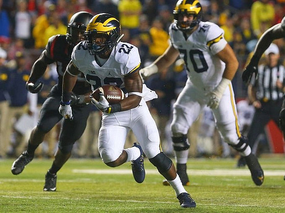 Karan Higdon (22) and Nolan Ulizio (70)