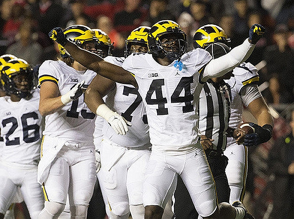 Jourdan Lewis (26), Chase Winovich (15), Maurice Hurst (73), and Delano Hill (44)