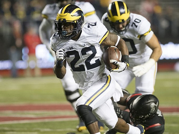 Karan Higdon (22) and Nolan Ulizio (70)
