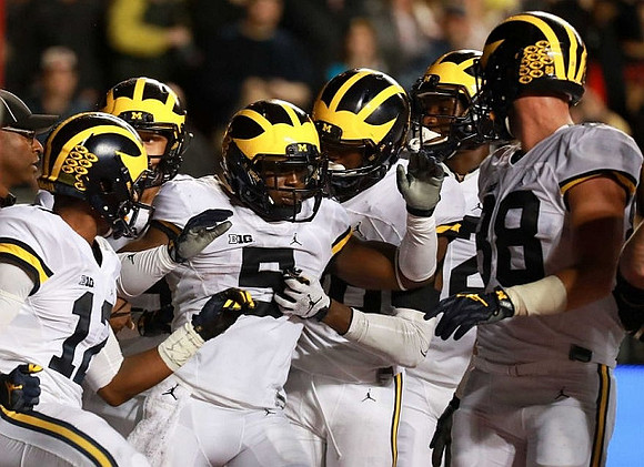 Chris Evans (12), Jabrill Peppers (5), and Jake Butt (88)