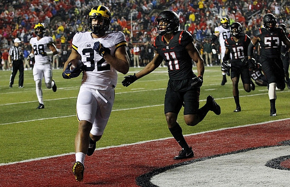 Jake Butt (88), Ty Isaac (32), and Kyle Kalis (67)