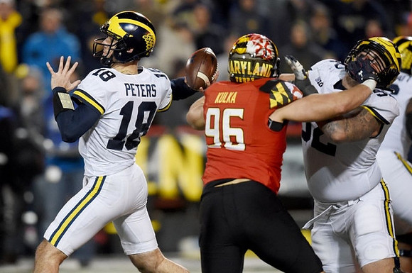 Brandon Peters (18) and Mason Cole (52)