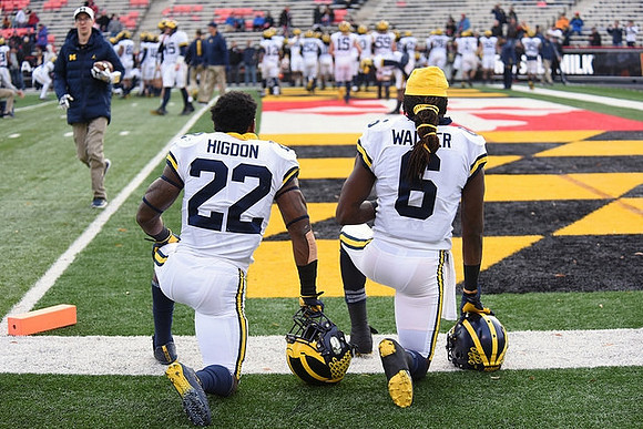 Karan Higdon (22) and Kareem Walker (6)