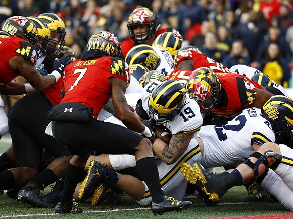 Henry Poggi (19), Ben Bredeson (74), Ben Mason (42), and Jon Runyan Jr. (75)