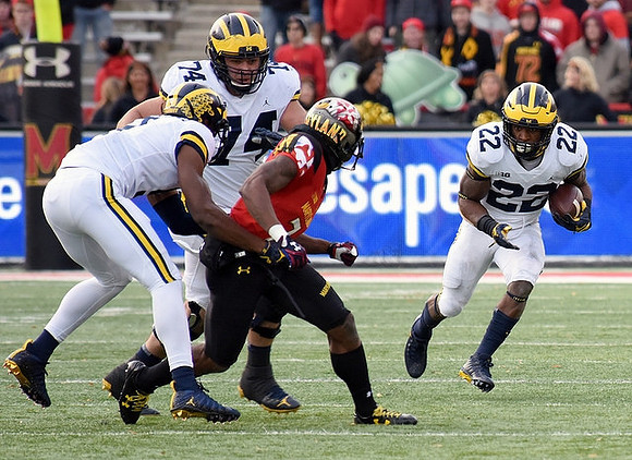 Ben Bredeson (74) and Karan Higdon (22)