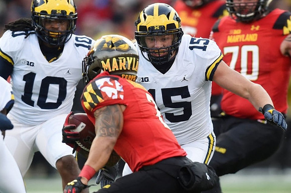 Devin Bush (10) and Chase Winovich (15)