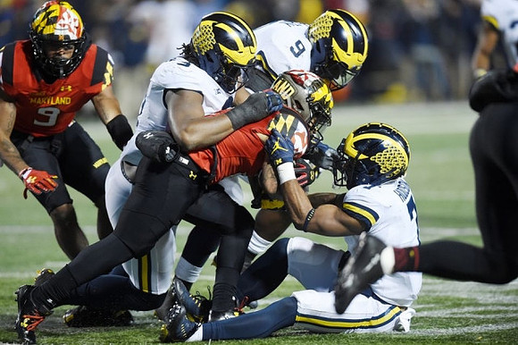 Rashan Gary (3), Mike McCray (9), and Khaleke Hudson (7)