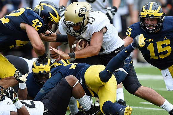 Ben Gedeon (42) and Chase Winovich (15)