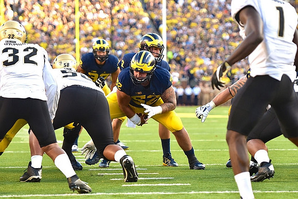 Mason Cole (52), Wilton Speight (3), and Ty Isaac (32)