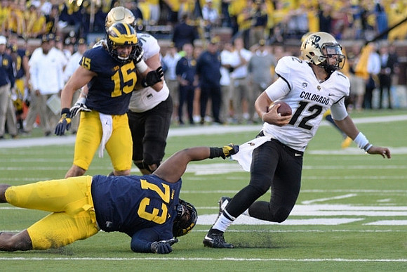 Chase Winovich (15) and Maurice Hurst (73)
