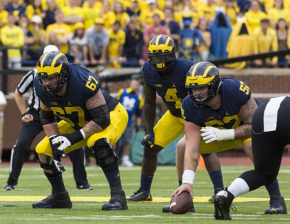 Kyle Kalis (67), De'Veon Smith (4), and Mason Cole (52)