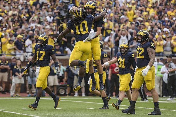Tyrone Wheatley Jr. (17), Devin Bush (10), Henry Poggi (19), Scott Sypniewski (31), and Mason Cole (52)
