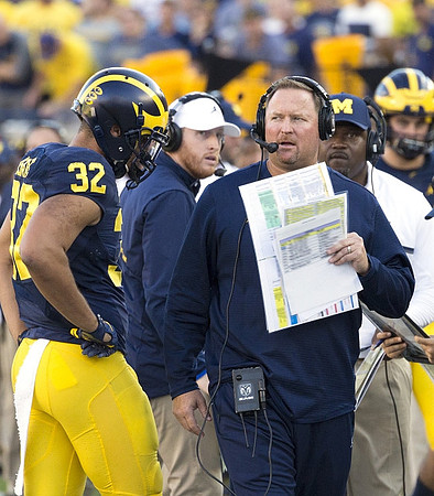 Ty Isaac (32), Jay Harbaugh, Tim Drevno, and Tyrone Wheatley Sr.