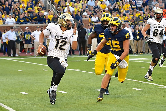 Maurice Hurst (73) and Chase Winovich (15)