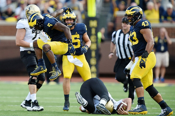 Jabrill Peppers (5), Chase Winovich (15), and Jeremy Clark (34)