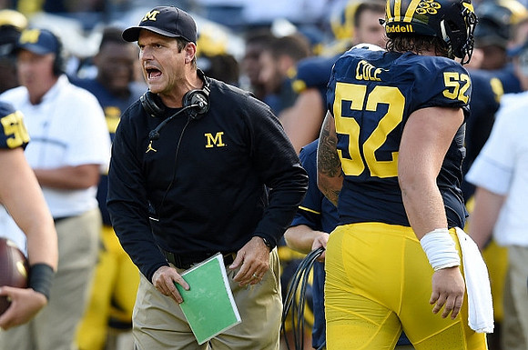 Jim Harbaugh and Mason Cole (52)