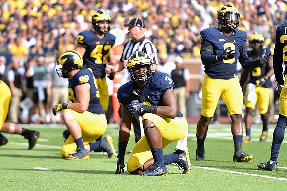 Matthew Godin (99), Ben Gedeon (42), Rashan Gary (3), and Mike McCray (9)