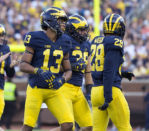 Eddie McDoom (13), Josh Uche (35), and Brandon Watson (28)