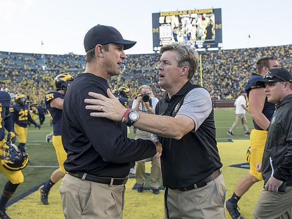 Jim Harbaugh and Colorado Head Coach Mike MacIntyre