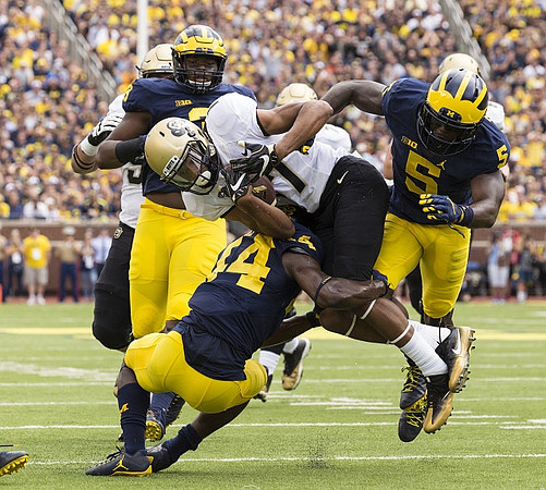 Rashan Gary (3), Jeremy Clark (34), and Jabrill Peppers (5)