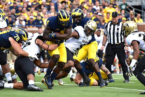 Erik Magnuson (78) and De'Veon Smith (4)