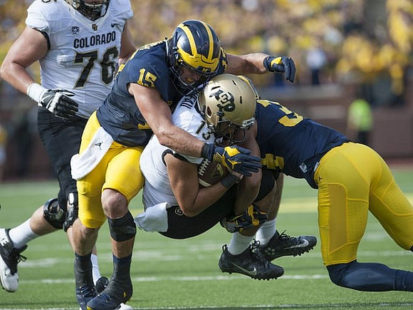 Chase Winovich (15) and Jeremy Clark (34)