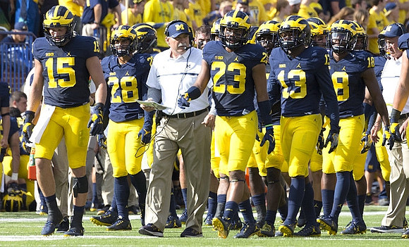 Chase Winovich (15), Brandon Watson (28), Don Brown, Tyree Kinnel (23), Josh Metellus (13), and AJ Pearson (18)