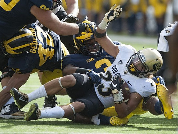 Ben Gedeon (42) and Rashan Gary (3)