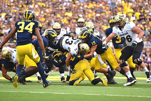 Jeremy Clark (34), Dymonte Thomas (25), Chase Winovich (15), and Rashan Gary (3)