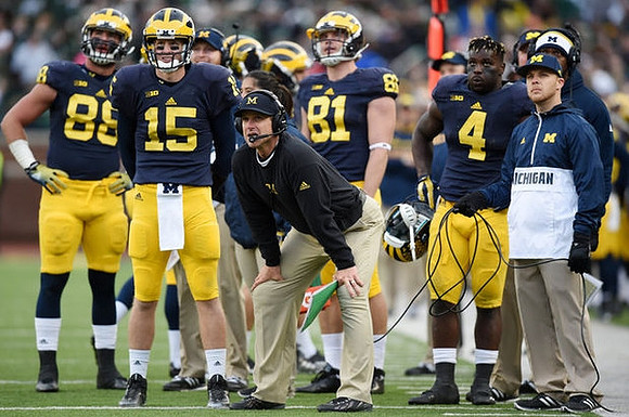 Jake Butt (88), Jake Rudock (15), Jim Harbaugh, Michael Jocz (81), and De'Veon Smith (4)