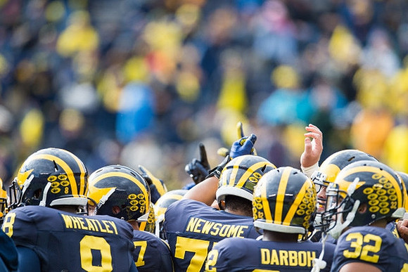 Tyrone Wheatley Jr. (8), Grant Newsome (77), Amara Darboh (82), and Ty Isaac (32)