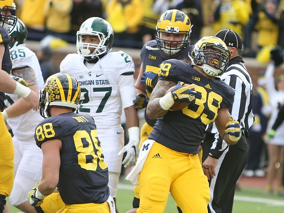 Jake Butt (88), Mason Cole (52), and Sione Houma (39)