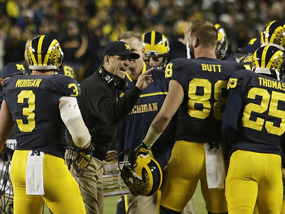 Desmond Morgan (3), Jim Harbaugh, Jake Butt (88), and Dymonte Thomas (25)