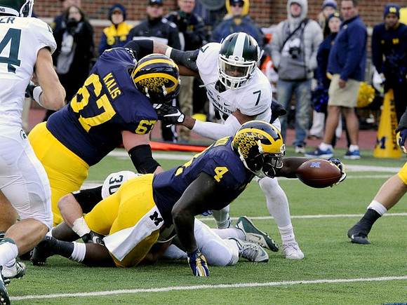 Kyle Kalis (67) and De'Veon Smith (4)