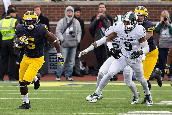 Jabrill Peppers (5) and Mason Cole (52)