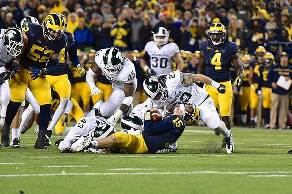 Mason Cole (52), Jake Rudock (15), and De'Veon Smith (4)