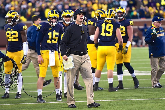 Amara Darboh (82), Jake Rudock (15), Jim Harbaugh, A.J. Williams (84), Henry Poggi (19), and Jake Butt (88)