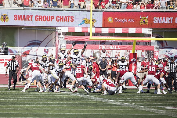 Josh Metellus (14), Maurice Hurst (73), and Tyree Kinnel (23)