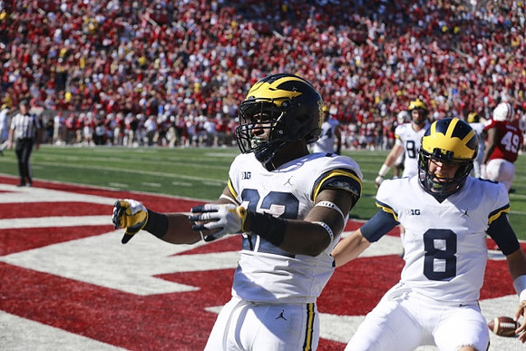 Karan Higdon (22) and John O'Korn (8)