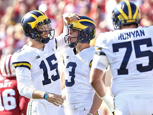 Garrett Moores (15), Quinn Nordin (3), and Jon Runyan Jr. (75)