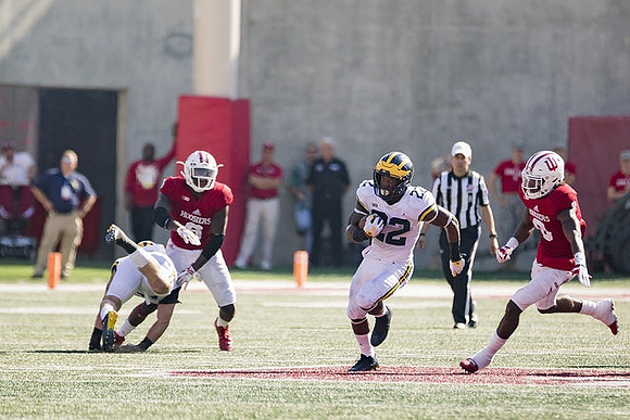 Henry Poggi (19) and Karan Higdon (22)