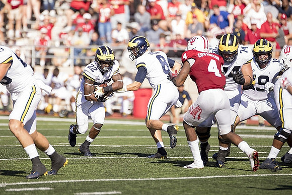 Karan Higdon (22), John O'Korn (8), Ben Bredeson (74), and Henry Poggi (19)