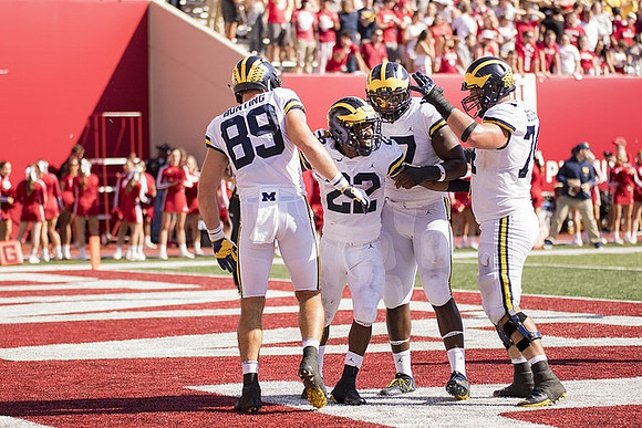 Ian Bunting (89), Karan Higdon (22), Tyrone Wheatley Jr. (17), and Ben Bredeson (74)