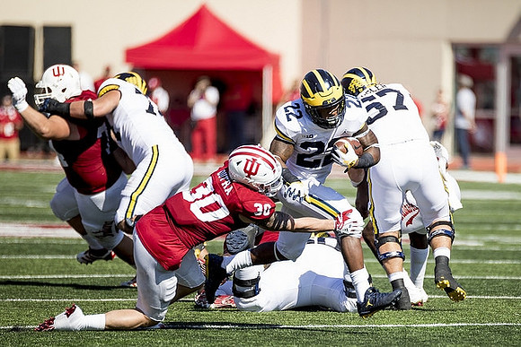 Ben Bredeson (74), Karan Higdon (22), and Patrick Kugler (57)