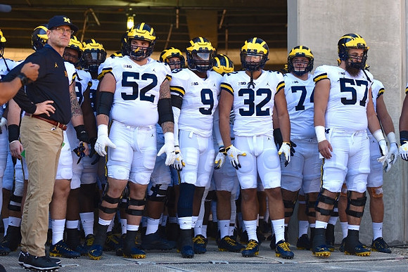 Jim Harbaugh, Mason Cole (52), Donovan Peoples-Jones (9), Ty Isaac (32), Ben Bredeson (74), and Patrick Kugler (57)