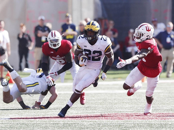 Henry Poggi (19) and Karan Higdon (22)