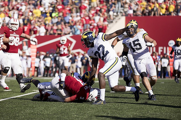 Josh Metellus (14), David Long (22), and Chase Winovich (15)
