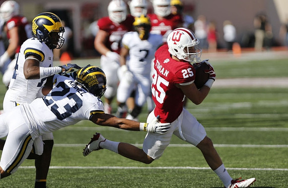Tyree Kinnel (23) and Josh Metellus (14)